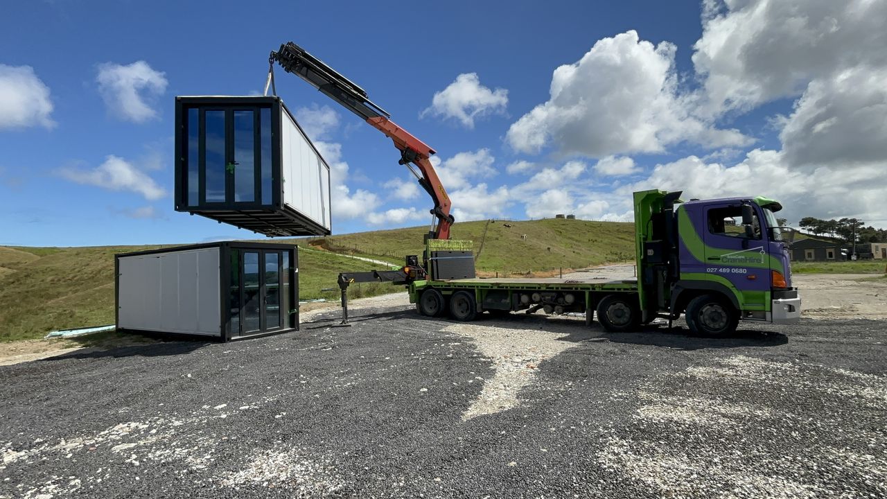 A portable building set down on a prepared site.