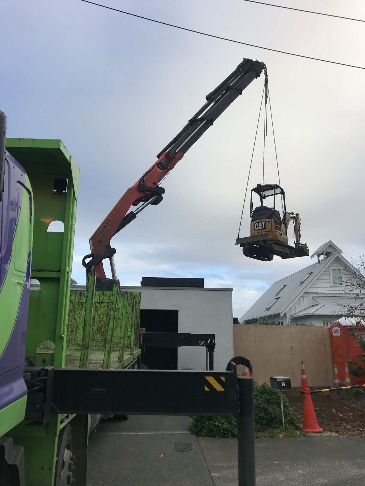 An awkward item craned into a rear yard.