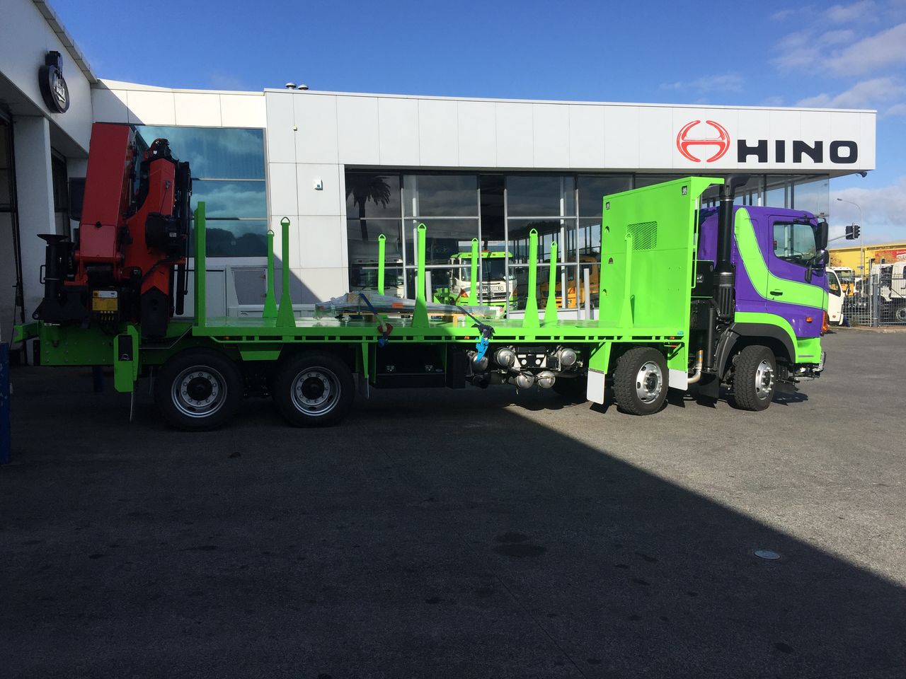 The TreeCare Crane Hire 8-wheeler Hino truck with rear-mounted Palfinger crane, side profile